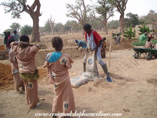 Oumar Degoga prepares the concrete for the water basin