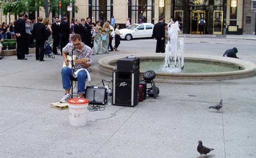 Blues guy playing in front of the Water Tower