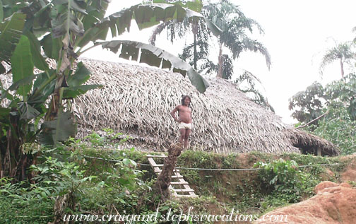Huaorani man in front of his house