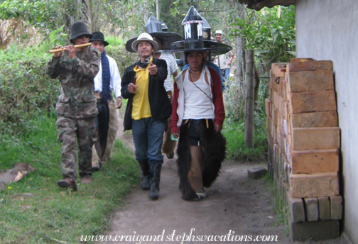 Inti Raymi dancers stop at the house for food and drink before marching to Cotacachi