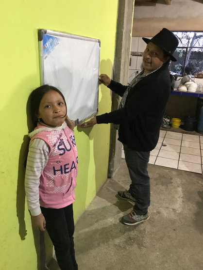 A new white board for Sisa to teach English to her siblings