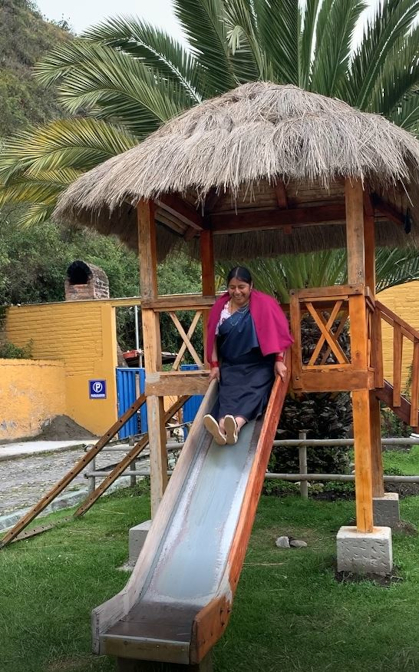 Rosa going down the slide at Lago Cuicocha