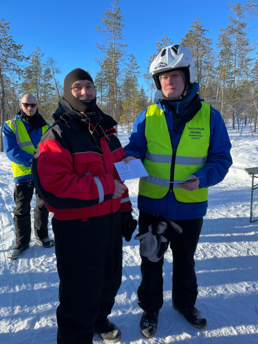 Craig getting his Finnish snowmobiling license from the cop