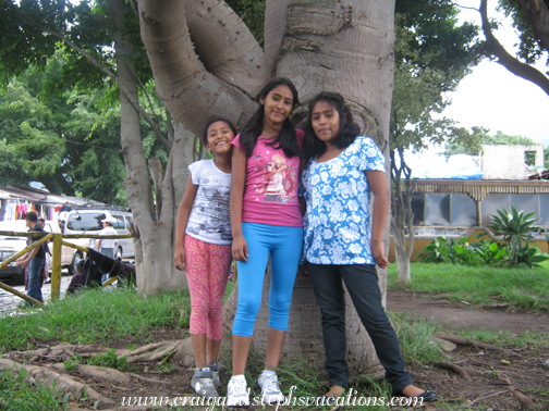 Yoselin, Vanesa, and Paola pose by a tree