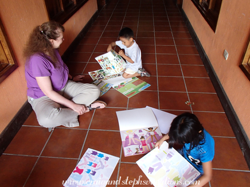 Steph, Aracely, and Eddy play with the sticker books
