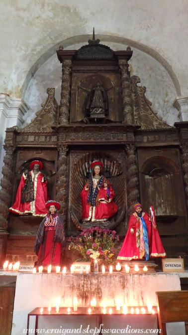 Shrine with saints wearing the traditional clothing of Santiago Atitlan