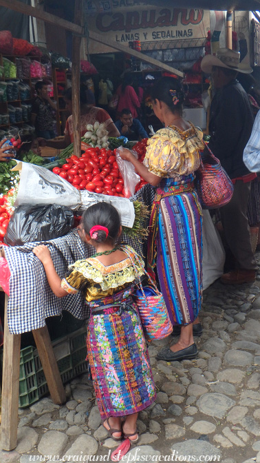 Mother and daughter buying tomatoes