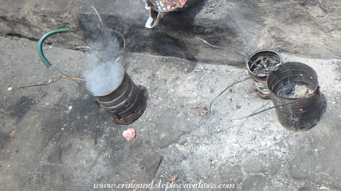Incense smoldering in primitive censers made from cofee cans