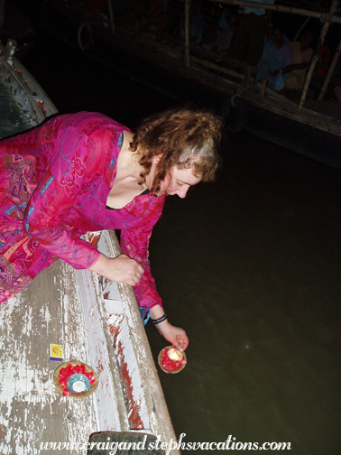 Lighting a candle and floating an offering into the Ganges