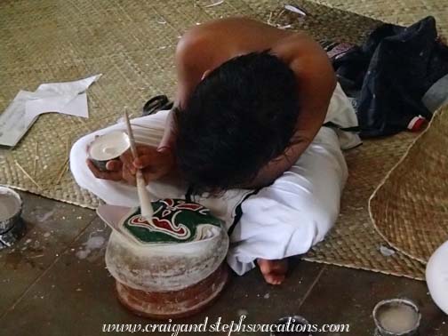 Practicing Kathakali make-up on a clay pot