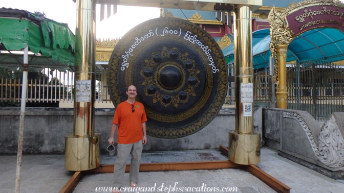 Craig stands next a large gong at Shwedagon