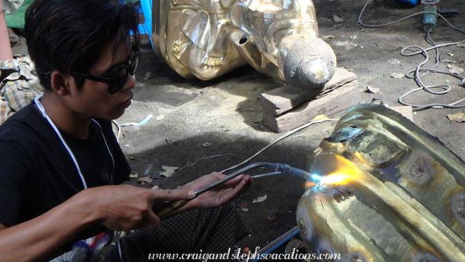 Soldering a bronze Buddha