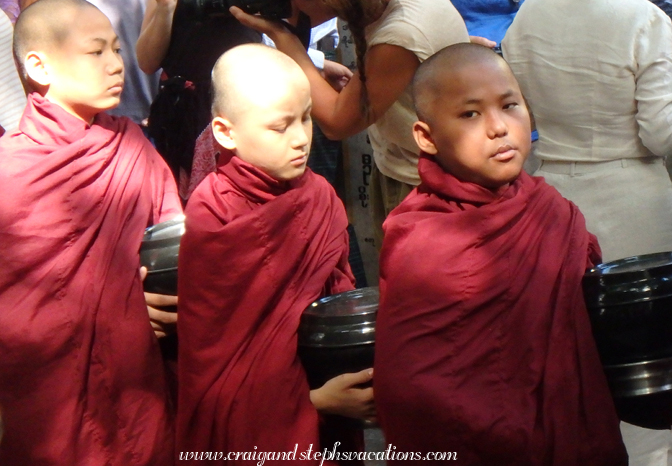 Monks queue for the last meal of the day at Mahagandayon Monastery