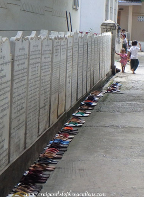 Flip-flops line an alley in Mahagandayon Monastery