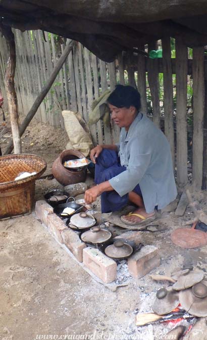 A woman cooks Burmese pancakes