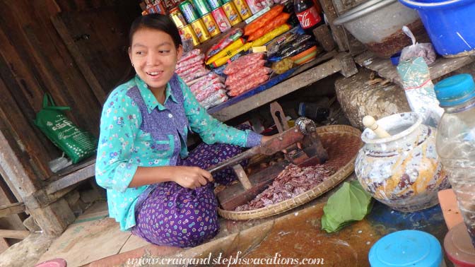 Young woman slicing areca nuts for betelnut preparation