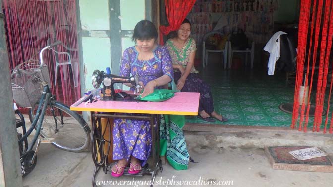 Woman sews a longyi