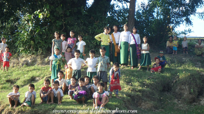 Villagers gather as we approach Tha Phan Seit Village