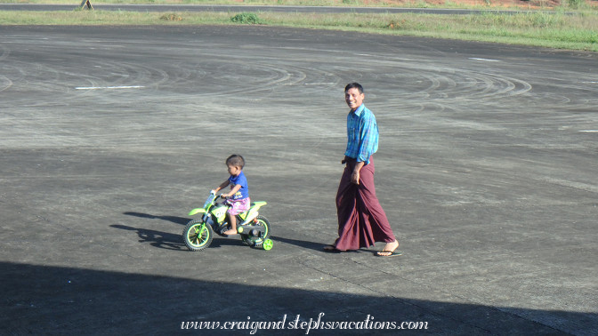 Little boy rides his motorized bike on the tarmac