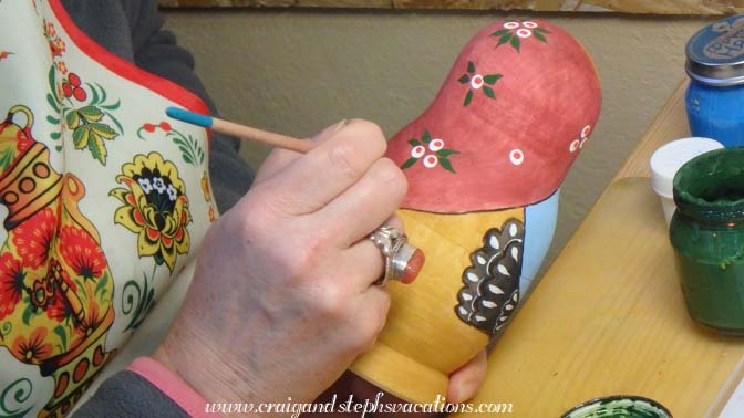 Aliona paints a replica of the first Russian nesting doll