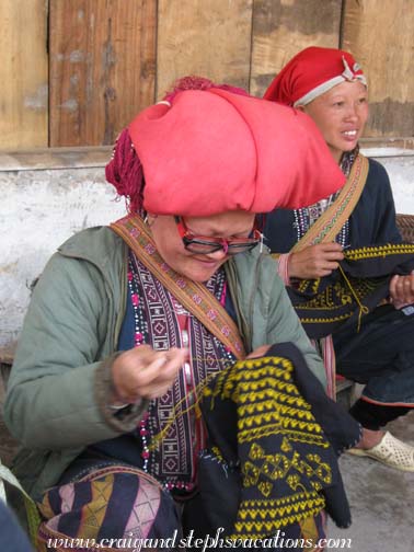Red Dao embroidery with two pairs of reading glasses