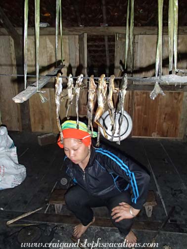 Yao woman with frogs drying by the fire