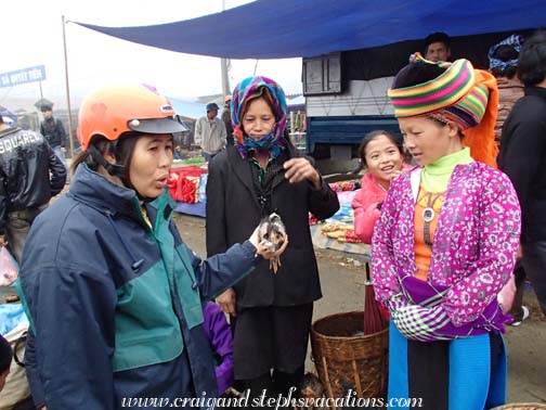 Selling a chicken at Tien Thang Market