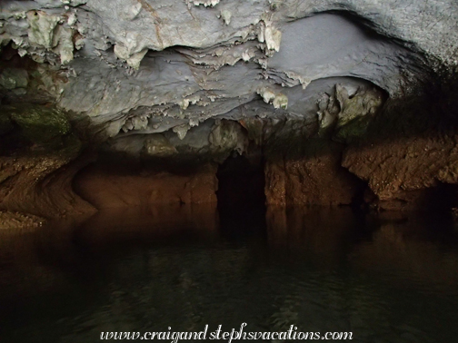 Kayaking through a cave to a hidden lagoon at Halong Bay