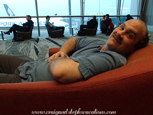 Craig in a comfy chair at Changi Airport