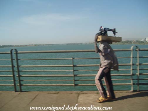 Man carries a sewing machine across the Niger