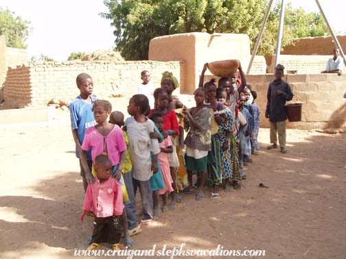 Kids lining up for sweets, Segoukoro