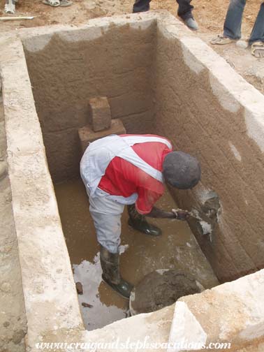 Mason Oumar Degoga cementing the pipe into place