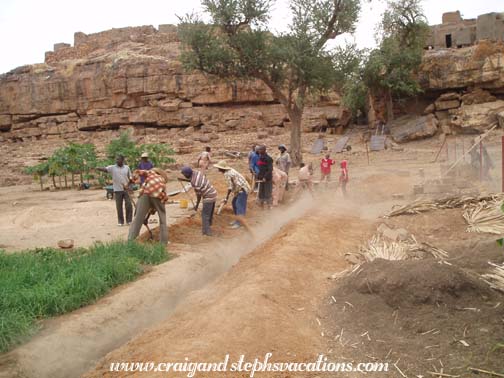 Village men fill in the trench