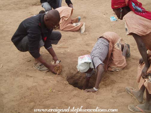 Fossenyi Sanago and a schoolgirl plant a tree