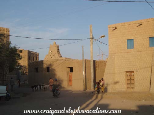 Goat herd, motorscooter, and Sankore Mosque