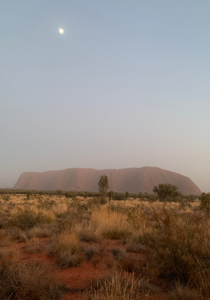 Moon over Uluru at sunrise