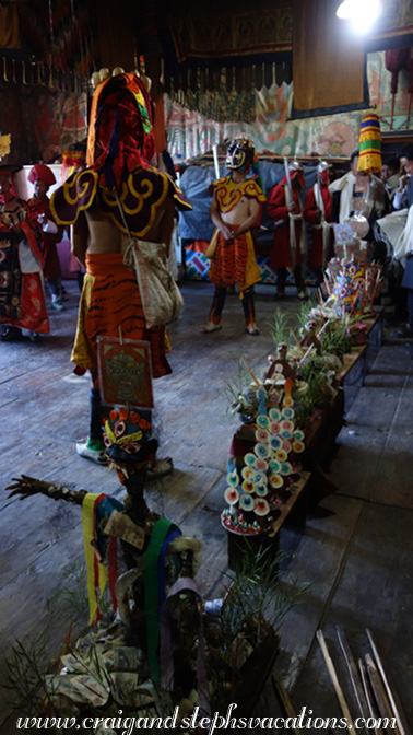 Effigy and ritual cakes, with masked mahakala dancers in the background