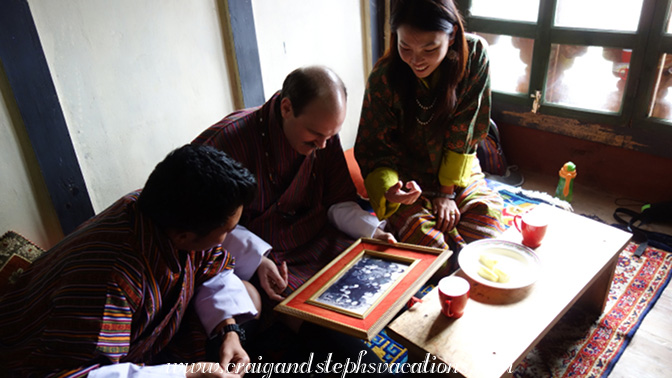 Kezang shows Craig some family photos