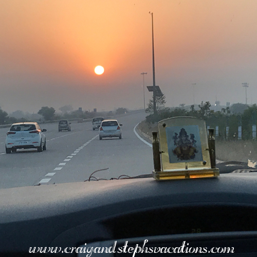 Driving toward the sunrise with Ganesha as our copilot