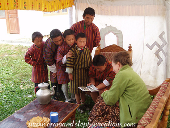 Showing Sonam Tshering (seated) photos from home, 2007