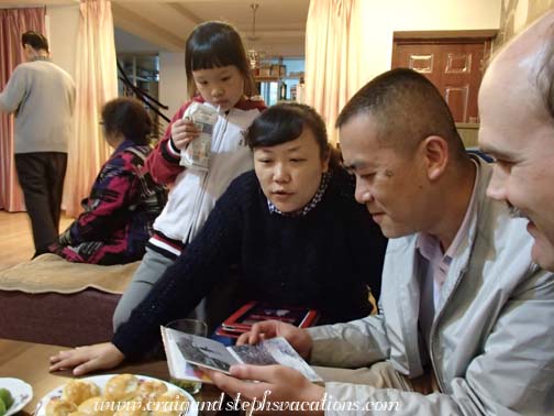 Wang Jun, Sara, and Sara's mom look at our photos