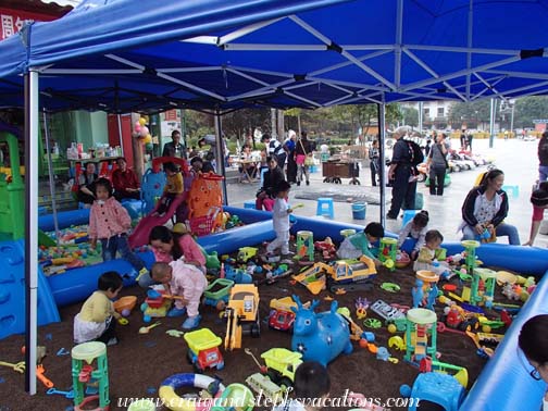 Kids play in a sandbox in Kaili square