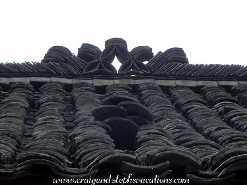 Coin-shaped tile roof adornment, Weng Xiang village