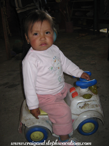 Sisa rides a car at the day care center