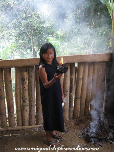 Anna demonstrates burning a termite mound to keep the bugs away