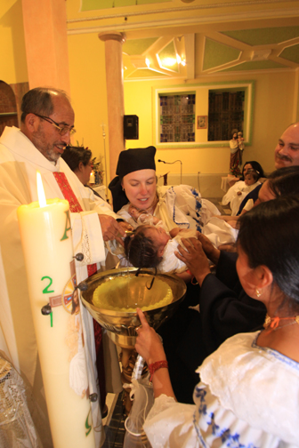 The priest baptizes Sisa (Photo courtesy of Felipe)