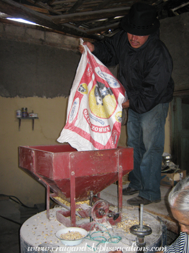 Antonio grinds corn in Quiroga