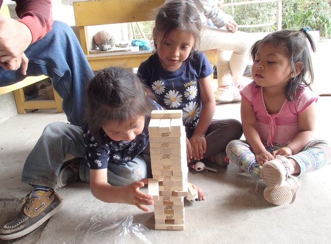 The kids playing Jenga