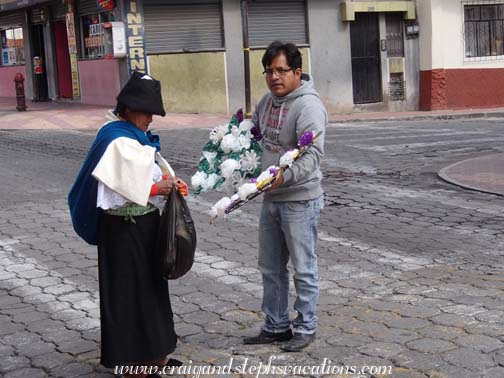 Man selling flowers to a woman for the cemetery