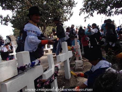 Woman offers food in the cemetery